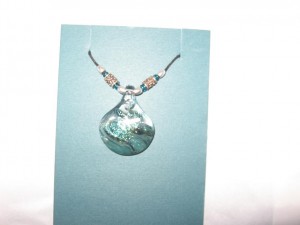 Pendant made from blown glass by artists from Victoria B.C. Value $60. Donated by Klaus Uhr, Switzerland.